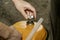 a man holds an orange gasoline canister in his hand next to the car unscrews the cork from the filler neck