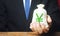 Man holds out a Yen yuan money bag. Provision of money on credit, grant. Project financing. Donations. Financial social assistance