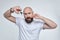 Man holds a pair of scissors intending to cut his moustache. shaving concept