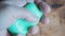 A man holds a piece of green soap in a wet palm. Lathers hand. Bathhouse. Preparation for washing. Background wood texture.