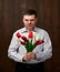 Man holds red flowers bouquet with awful smell