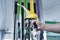 Man holds a refueling gun in his hand for refueling cars. Gas station with diesel and gasoline fuel close-up