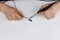 Man holds soldering iron in his dirty hands and solders the cable on white table. Home work concept. Copy space for text