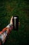 a man holds a thermos in his hand during the rain