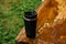 a man holds a thermos in his hand during the rain