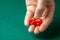 Man holds two red dices and throws them on green poker gaming table in casino. Concept of online gambling, winner or player