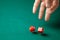 Man holds two red dices and throws them on green poker gaming table in casino. Concept of online gambling, winner or player