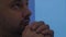 Man at home, looking up, praying prayer, thinking. Portrait, closeup, 4 k.