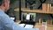 Man at home office study online webinar webcam laptop, drinking coffee tea