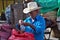 Man on a Honduras market packing tamarind for sale