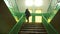 A man with a hood on his head climbs the stairs at school, background, college