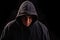 Man with hoodie or hooligan over dark background