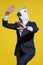 Man with horse mask on yellow background