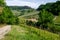 Man on a horse rides among Vineyard with Monforte dâ€™Alba village. Pathway from Barolo