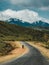 Man on horse riding on Street in steppe with Tian Shan mountains in background, Kazakhstan Central Asia