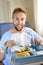 Man in hospital room eating healthy diet clinic food in happy satisfied face expression