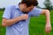 Man with hyperhidrosis sweating very badly under armpit in blue shirt, isolated on grey