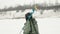 Man with ice drill and fishing bag with equipment is walking on frozen ice thick. Winter fishing. Fisherman at frozen lake