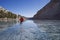 Man Ice Skating On Frozen Mountain Lake