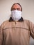 Man with improvised medical mask made of cloth, looks directly into the camera