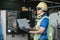 Man Industrial engineers wearing safety uniform and hard hats with laptop working.