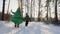 Man in an inflatable costume of the Christmas tree walking with a child in the park