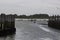 A man in an inflatable dinghy rows against a stiff breeze towards the slipway in Bosham Harbour in West Sussex