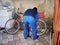 a man inflates a bicycle wheel pump