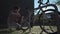 Man inflates tire with small hand pump in a bicycle parking lot in Germany. The topic is amateur bicycle maintenance