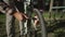 Man inflates tire with small hand pump in a bicycle parking lot in Germany. The topic is amateur bicycle maintenance