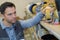 Man inspecting trolley wheels in factory