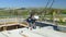 A man is installing a concrete slab on the roof of the building