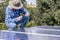 man installing connect power solar panels on a roof house for alternative energy photovoltaic safe energy. power from