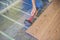 Man installing new wooden laminate flooring. infrared floor heat