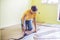 Man installing new wooden laminate flooring. infrared floor heat