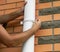 Man installing rain gutter system