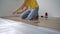 A man installs laminate on the floor in their apartment. DIY concept