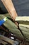 A man installs a thermal insulation layer of a thermal roof - using panels of mineral wool, mounting it between the beams of the