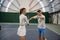 Man instructor with woman training tennis collaborating on effective techniques
