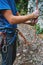 A man insures climber through a belay device.