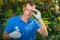 Man investigates liquid fertilizer for plants in the greenhouse