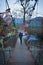 Man at iron suspension bridge with many blurred buddhist flag at evening from flat angle