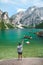 man with italian flag at beach of Braies lake in Dolomites mountains
