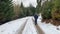 Man in jacket walk in the winter through a snowy forest