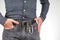 Man in jeans on a leather belt with a flashlight and a knife. survival items