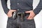 Man in jeans on a leather belt with a flashlight and a knife. survival items