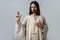 Man in jesus robe gesturing isolated on grey