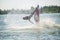 Man on jet ski turns with much splashes