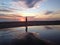 Man jogger running on sunset beach with reflection