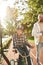 Man jogging and boy with disability riding bicycle